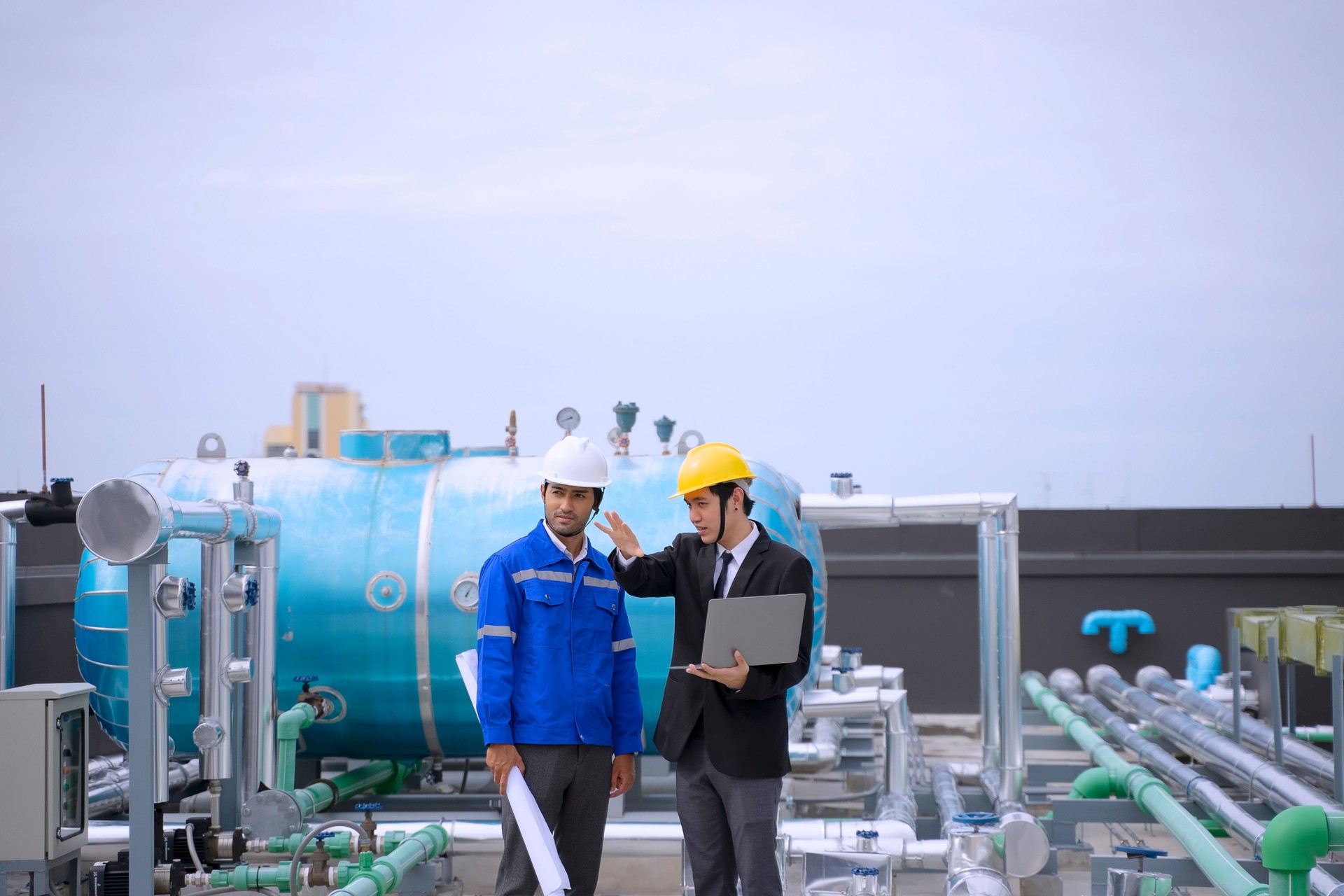 Engineers are checking HVAC system at rooftop.